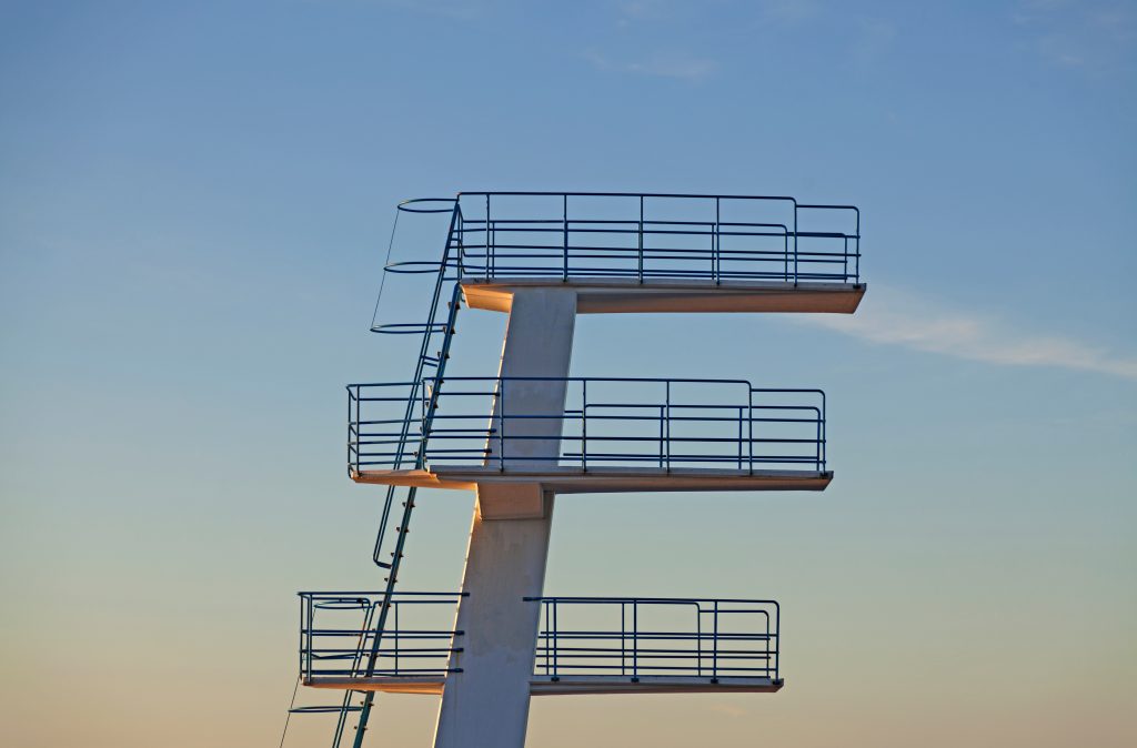 swimming jumping tower in sunset